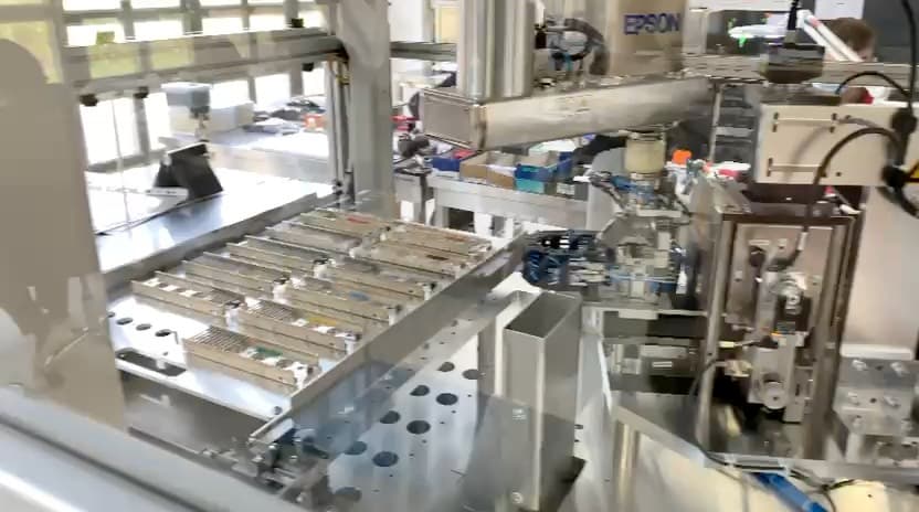 Automated kraftwerk production line handling tubes on metal trays